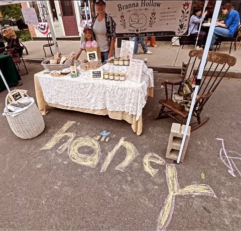 The farmer and her daughter behind the Branna Hollow Farm table at a Hudson market.