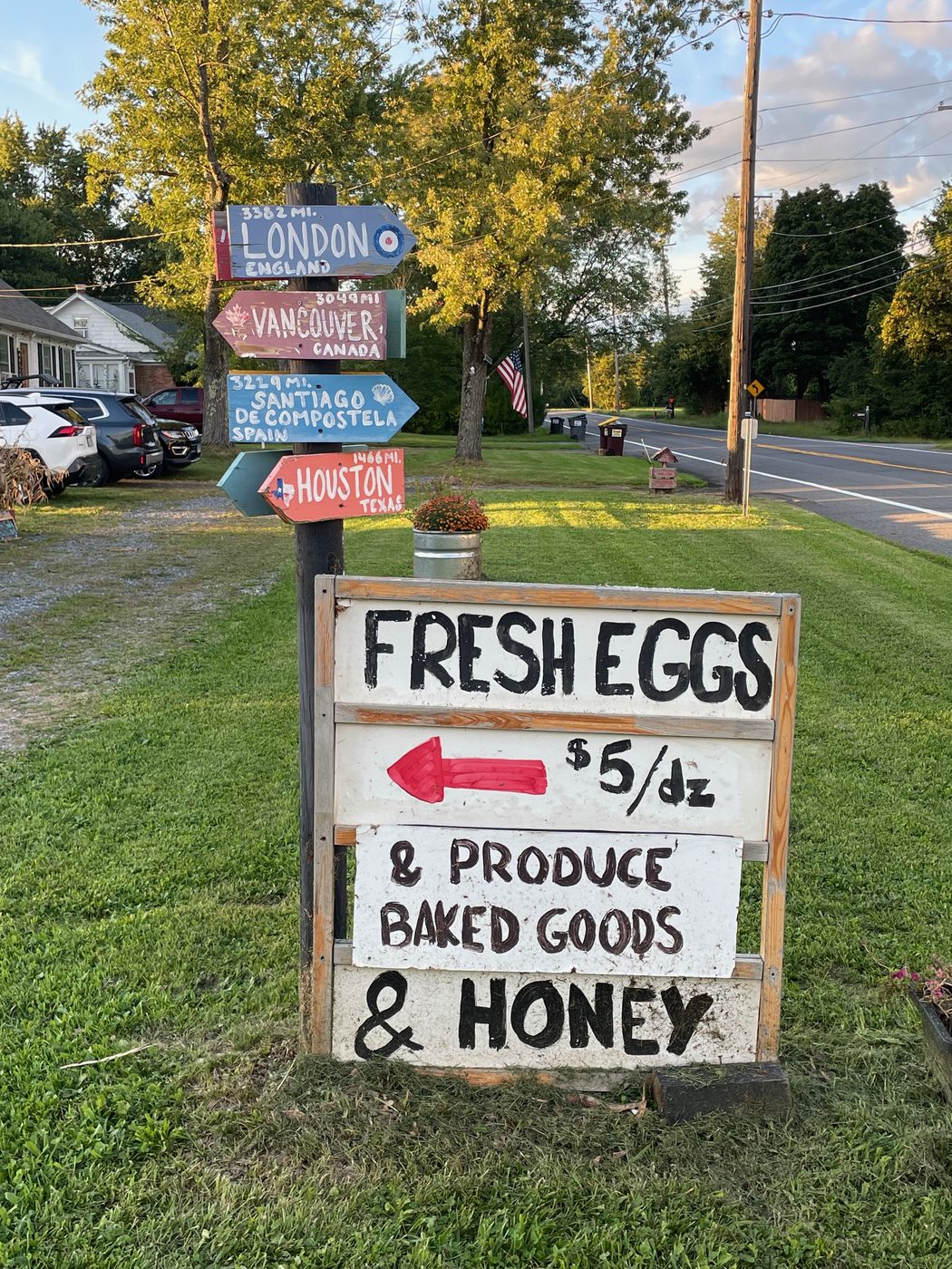 The hand-lettered roadside sign: fresh eggs $5 a dozen, produce, baked goods and honey.